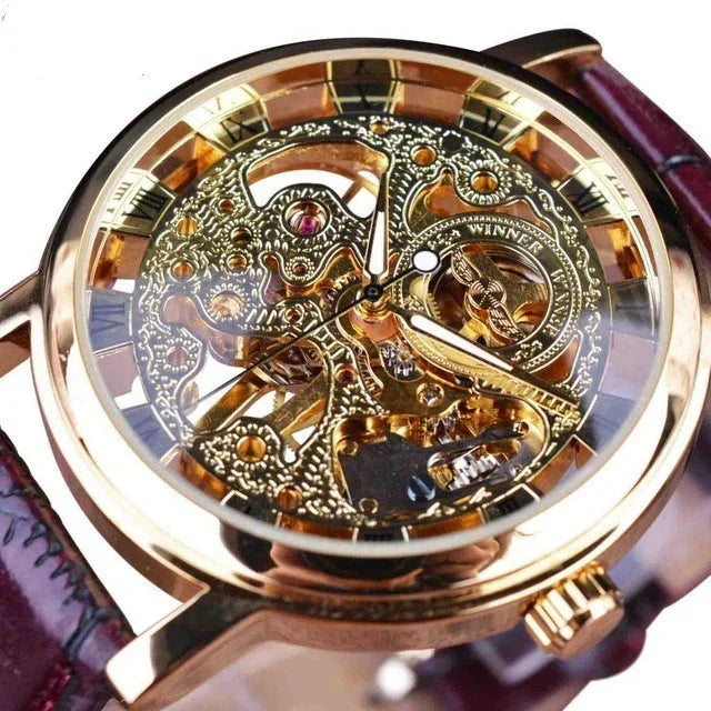 skeleton mechanical wristwatch with gold-tone gears, roman numerals on dial, and brown leather strap