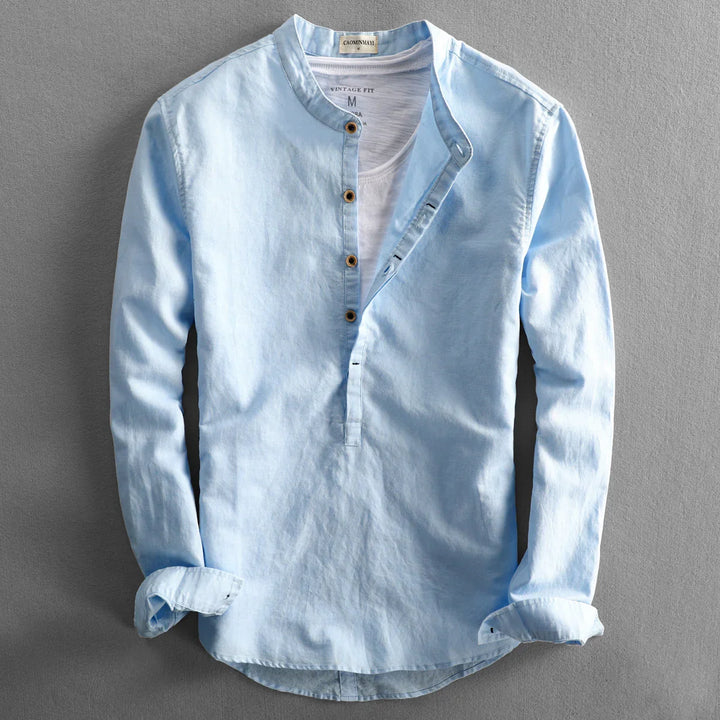 Light blue casual men's shirt with mandarin collar and button placket on gray background
