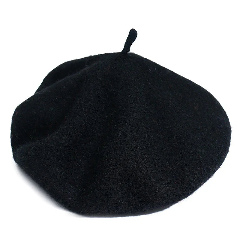 Classic black wool beret with small top stem on white background