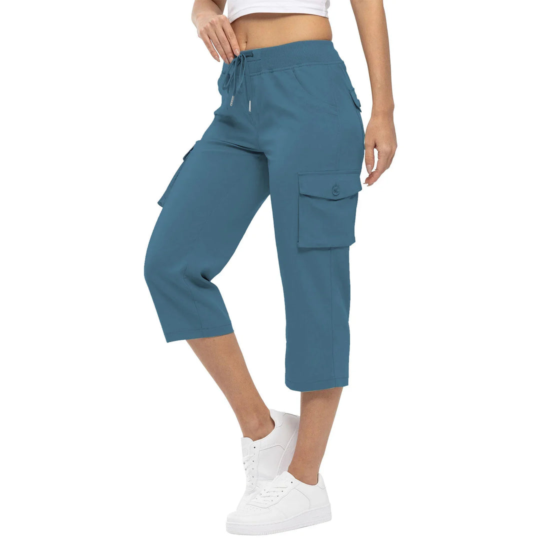 Woman wearing blue cropped cargo pants with drawstring waist and white sneakers