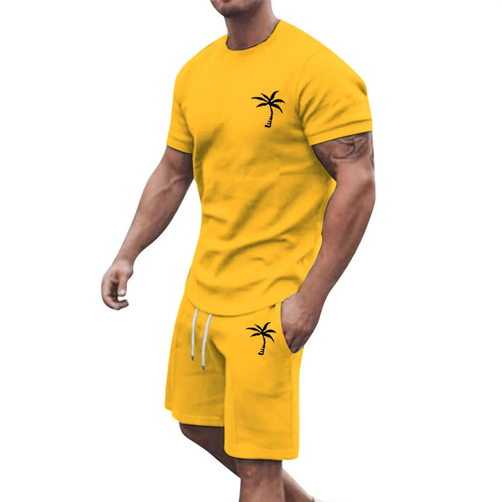 Man wearing yellow casual short sleeve t-shirt and shorts set with black palm tree prints