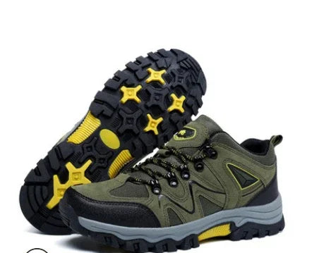 Green and black hiking shoes with rugged yellow and black soles, designed for outdoor trekking.