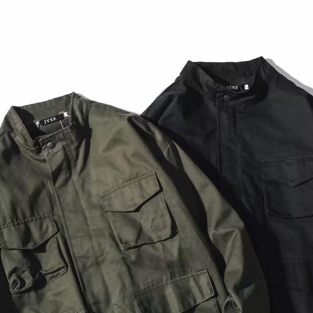 Two lightweight utility jackets in olive green and black with button collars and multiple front pockets