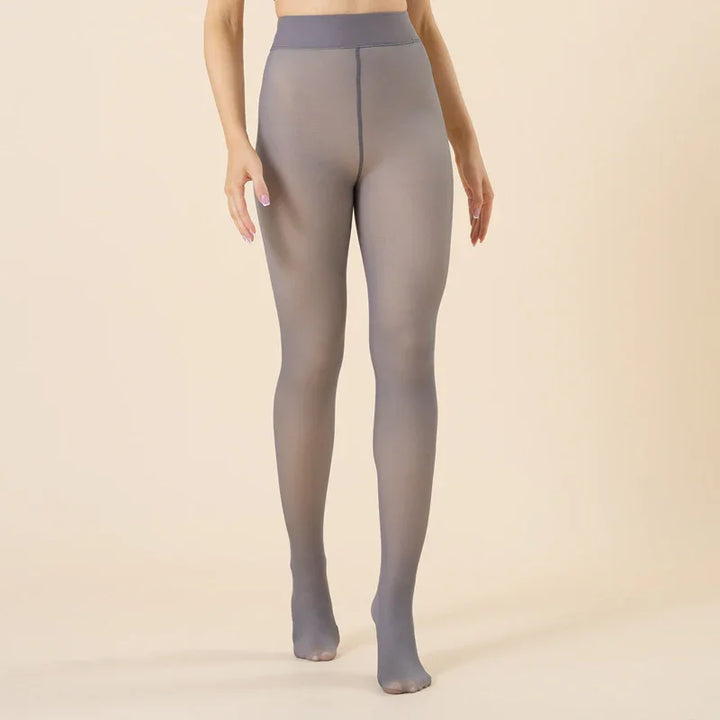 Woman wearing high-waist sheer gray tights with opaque waistband on beige background