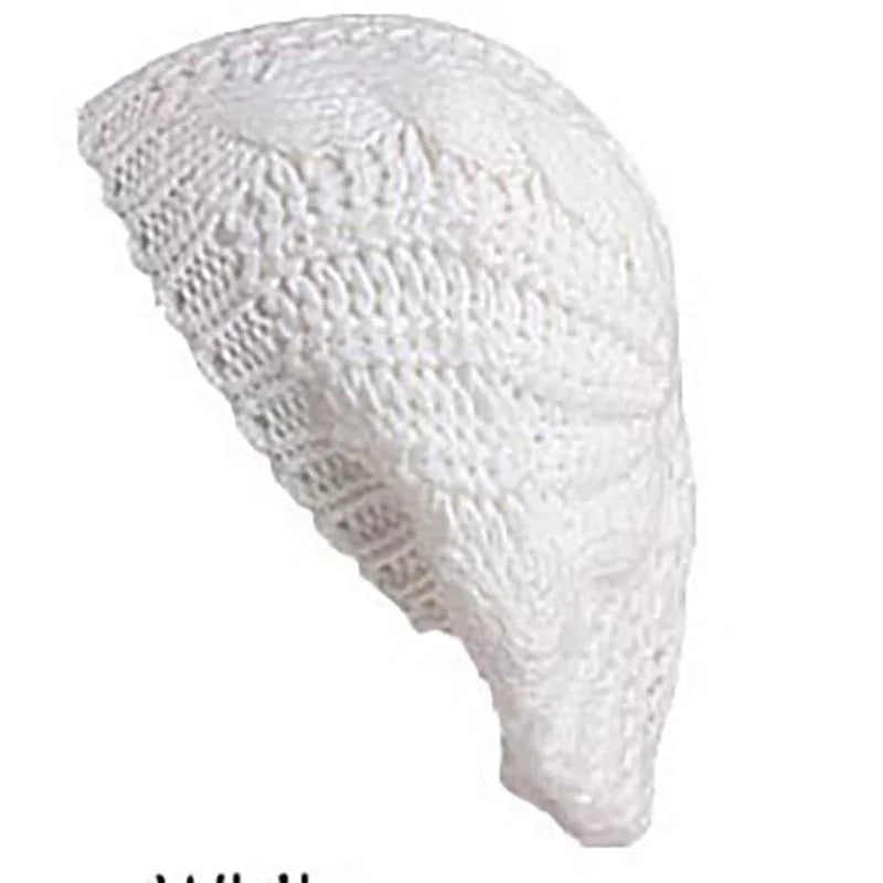 White knitted crochet beret hat with textured pattern on a white background