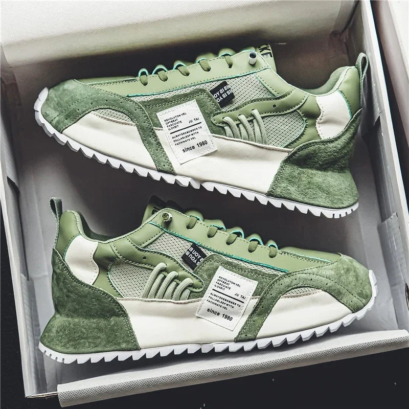 Pair of green and white casual sneakers with textured panels and white soles in a shoe box