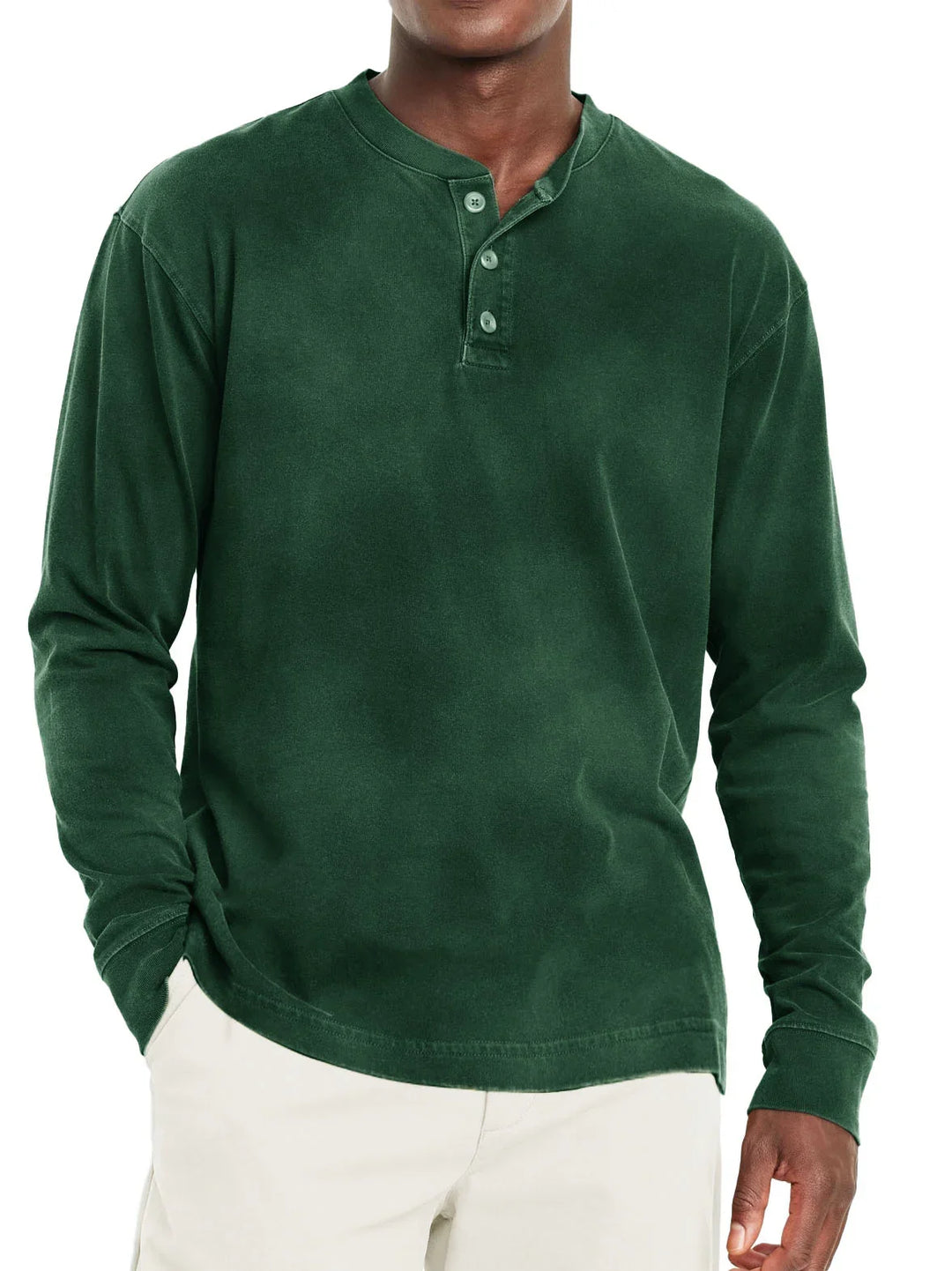 Man wearing dark green long sleeve henley shirt with three buttons and beige pants