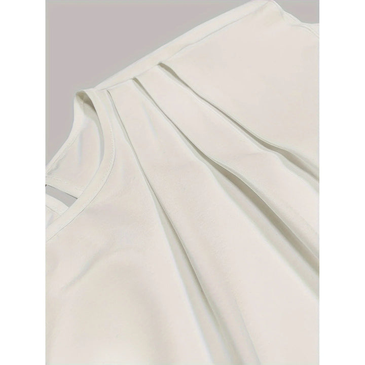 Close-up of white sleeveless top with pleated front detail on plain background