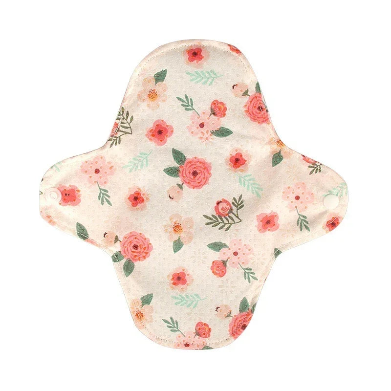 Reusable cloth menstrual pad with pink and red floral print on light beige background