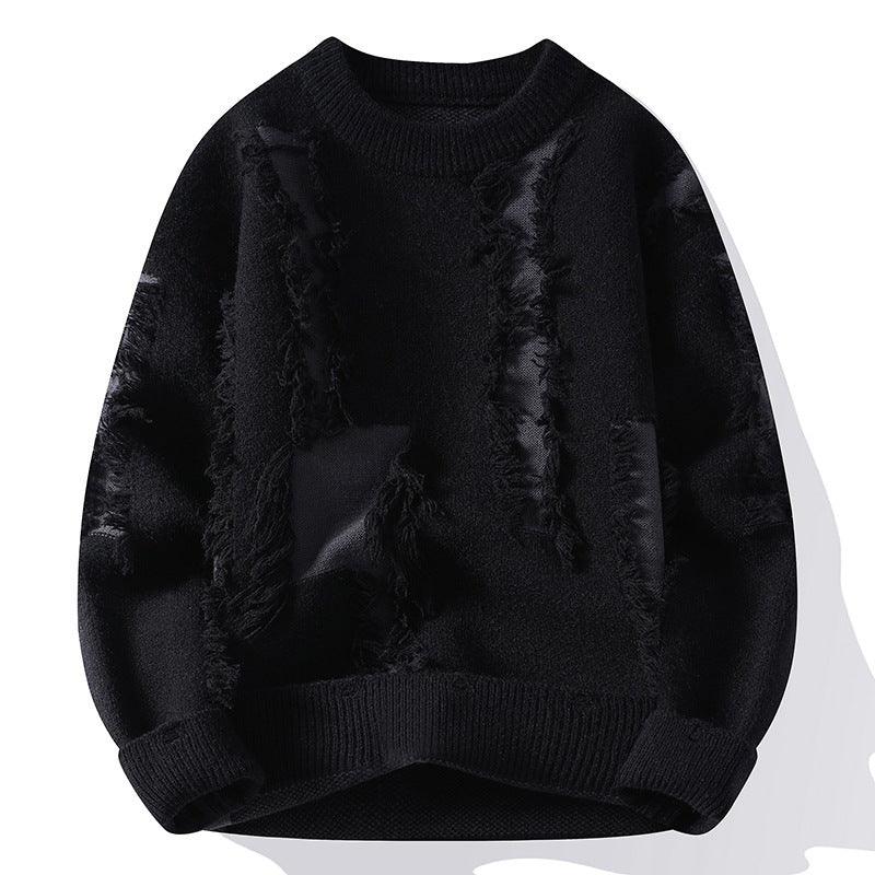 Black knit sweater with distressed, frayed patches and ribbed cuffs and hem