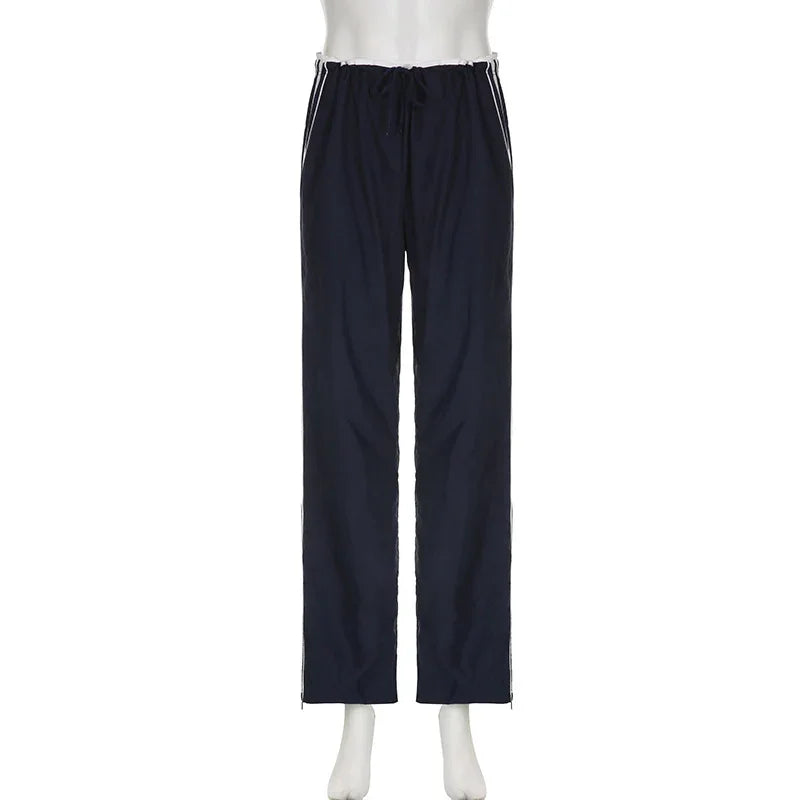 Navy blue athletic pants with white side stripes and drawstring waist on mannequin