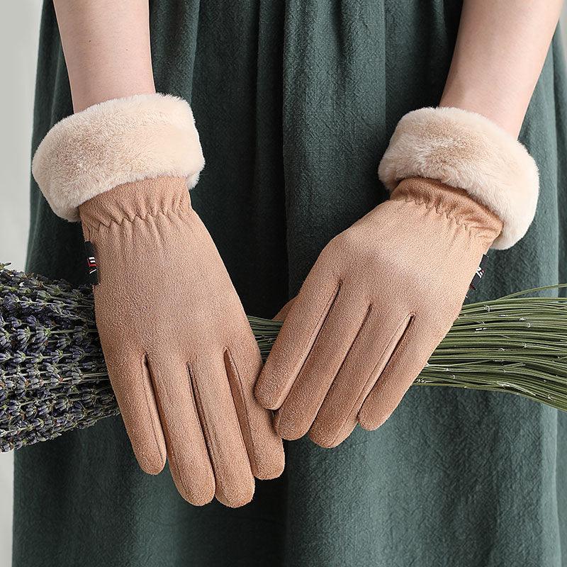 hands wearing soft brown suede gloves with beige fur cuffs holding dried lavender bundles