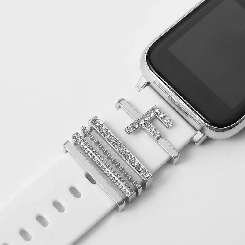 White smartwatch band with silver and rhinestone decorative charms on a white background