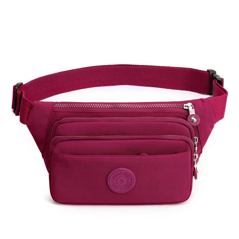 Stylish maroon waist bag with adjustable strap, multiple zippered compartments, and circular logo