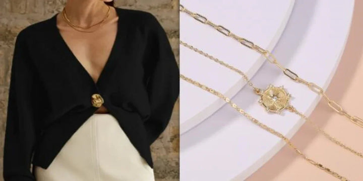 Woman wearing black deep V-neck cardigan with gold button and layered gold chain necklaces with floral pendant