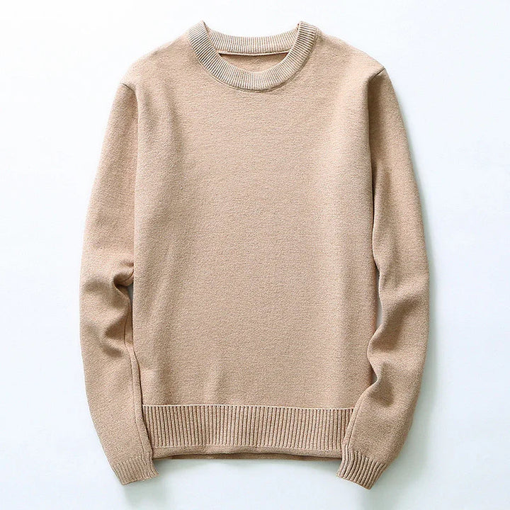 Beige crewneck knit sweater with long sleeves and ribbed cuffs and hem on white background