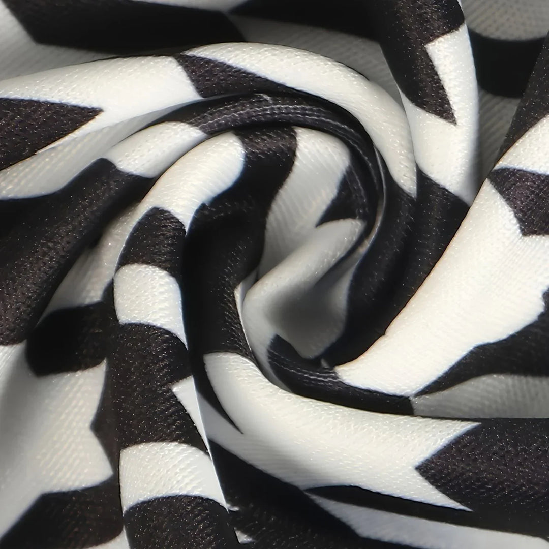 Close-up of black and white zigzag patterned fabric with smooth, shiny texture