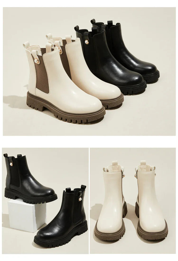 Black and white leather Chelsea boots with chunky lug soles and decorative pearl buttons on beige background