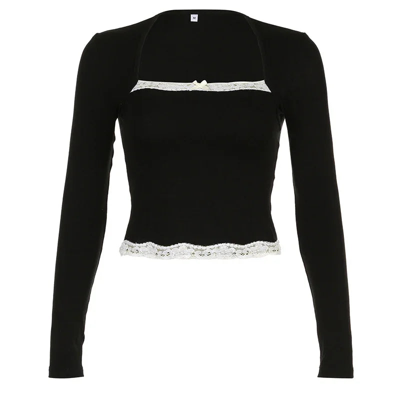Black long-sleeve crop top with white lace trim and small front bow detail