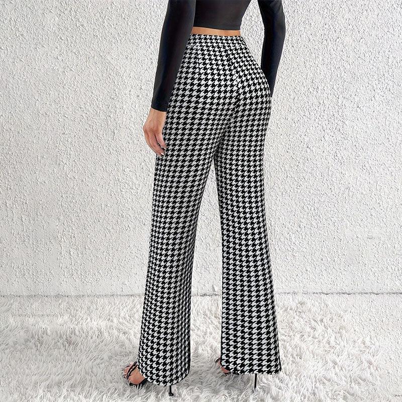 Woman wearing black and white houndstooth wide-leg pants with black long sleeve crop top