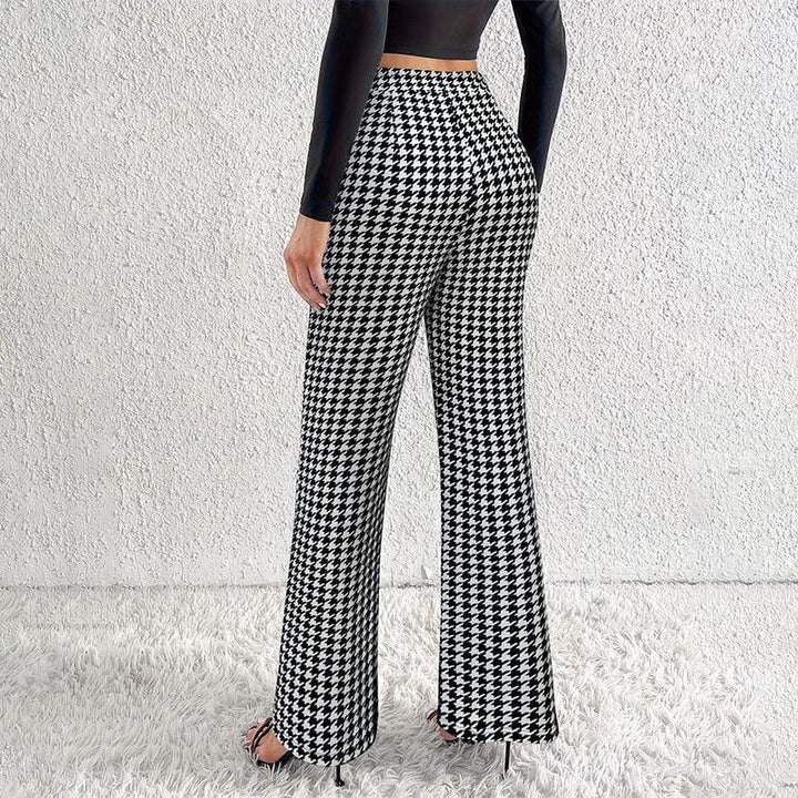 Woman wearing black and white houndstooth wide-leg pants with black long sleeve crop top