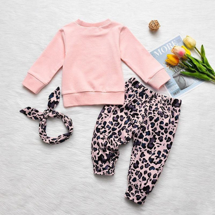 Pink long-sleeve toddler sweatshirt with leopard print pants and matching headband on white background