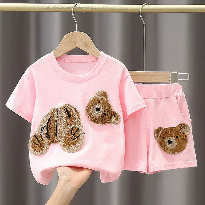 Pink toddler outfit with teddy bear patches on short-sleeve shirt and shorts