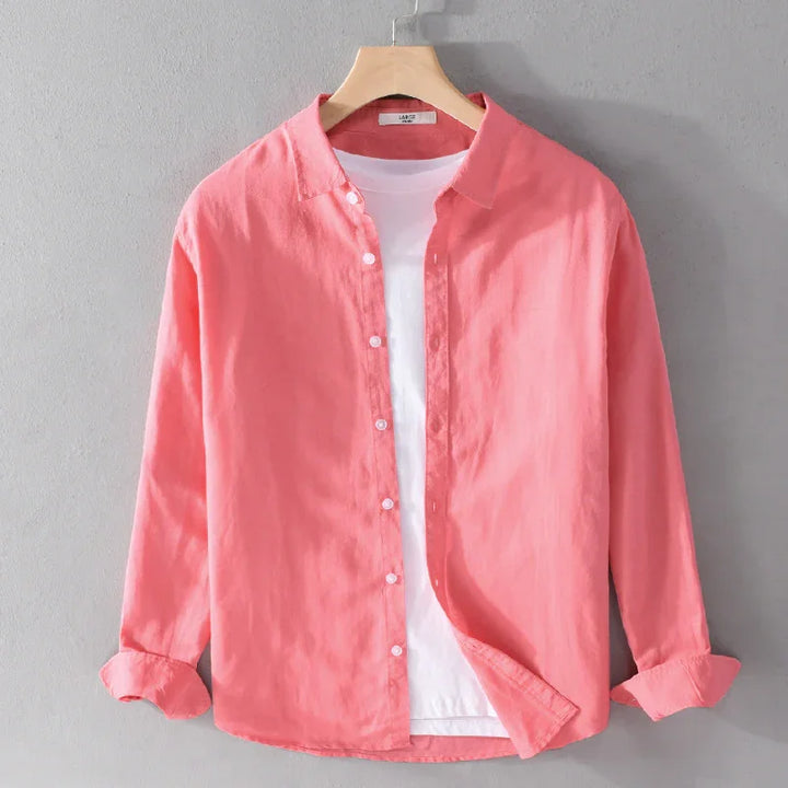 Coral pink long-sleeve button-up shirt layered over a white crew-neck t-shirt on wooden hanger