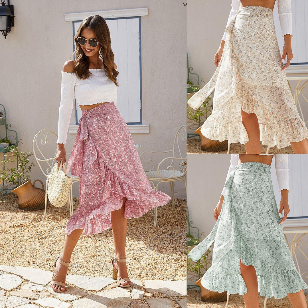 Women modeling floral wrap skirts in pink, cream, and mint green with ruffles and tied waist outdoors