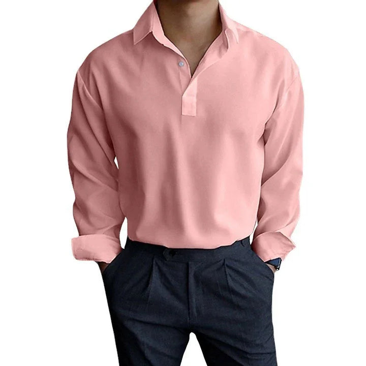 Man wearing a pink long-sleeve polo shirt with black pants, casual smart outfit