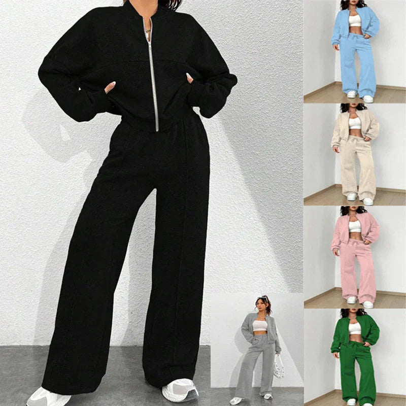 Woman modeling black zip-up wide-leg pantsuit in outdoor white wall setting with six color variations
