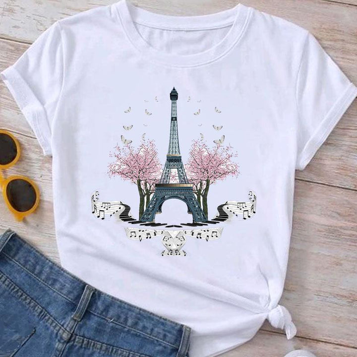 White t-shirt with Eiffel Tower graphic, pink cherry blossoms, butterflies, and musical notes design