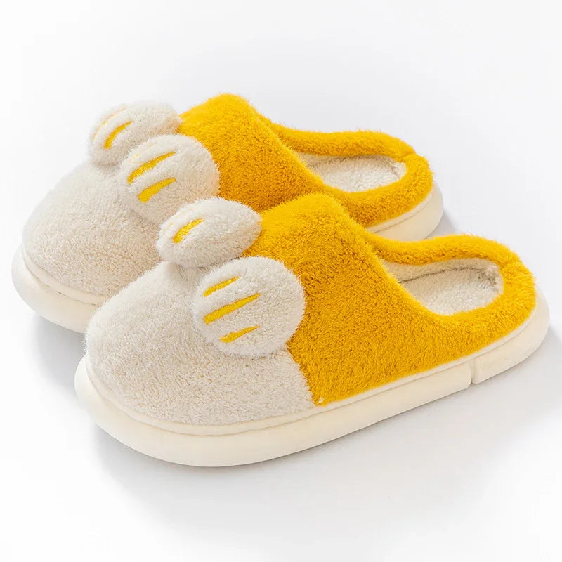 Cozy yellow and cream plush slippers with fuzzy texture and decorative ear accents
