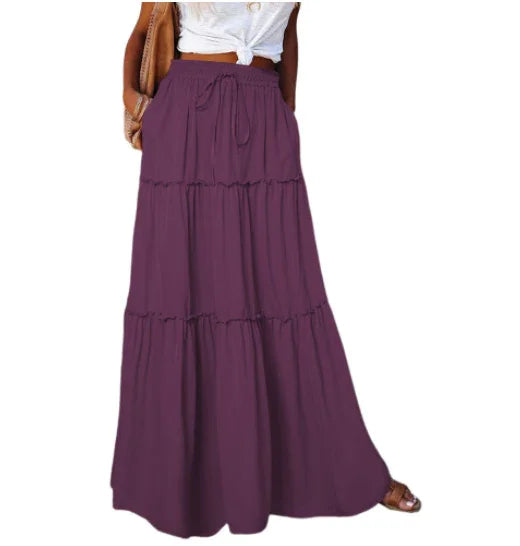 woman wearing high-waisted purple maxi skirt with tiered design and drawstring waist