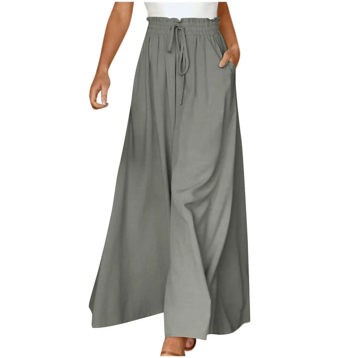 Woman wearing high-waisted gray wide-leg pants with drawstring and pockets