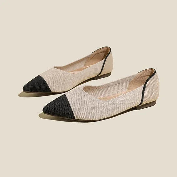 Beige and black pointed-toe flat shoes on neutral background, stylish women's footwear