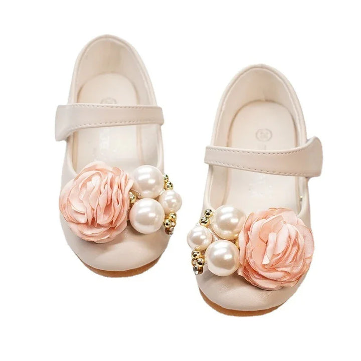 White toddler Mary Jane shoes with pink fabric flowers and pearl bead embellishments