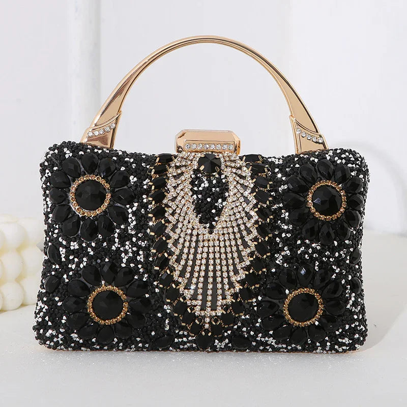 Black jeweled evening handbag with gold handle and intricate crystal floral designs
