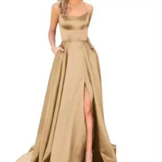 Elegant woman wearing a gold satin ball gown with a thigh-high slit and pockets