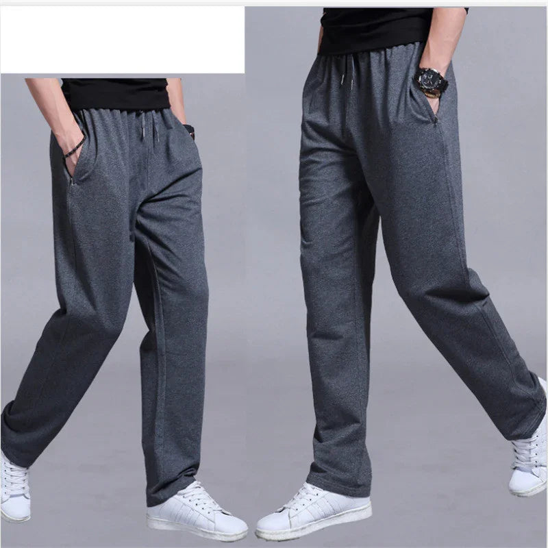 Grey casual jogger pants with elastic waistband and pockets worn with white sneakers