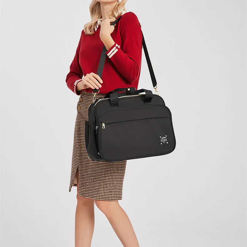 Woman in red sweater and checkered skirt carrying large black laptop shoulder bag