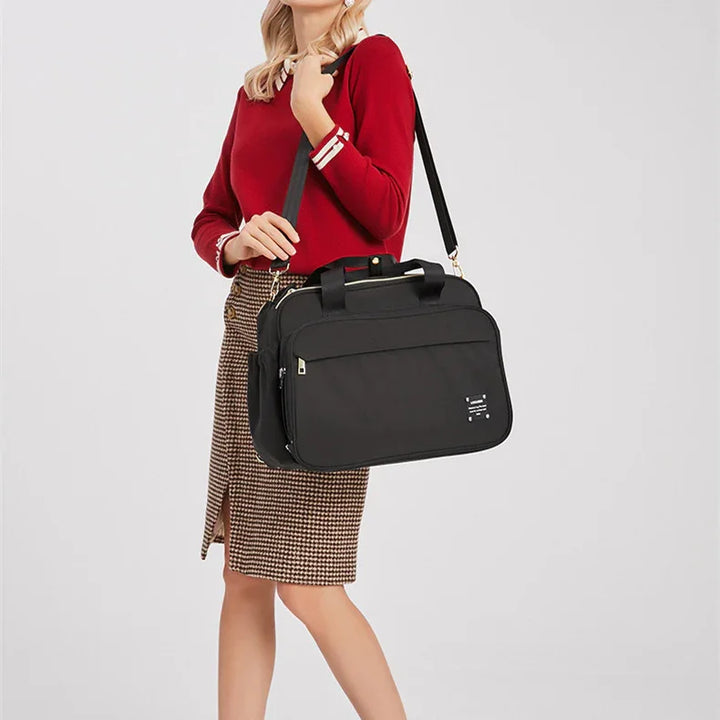 Woman in red sweater and checkered skirt carrying large black laptop shoulder bag