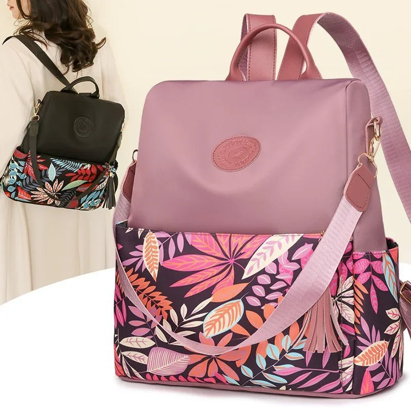 Stylish floral patterned backpacks in pink and black with leafy designs and adjustable straps