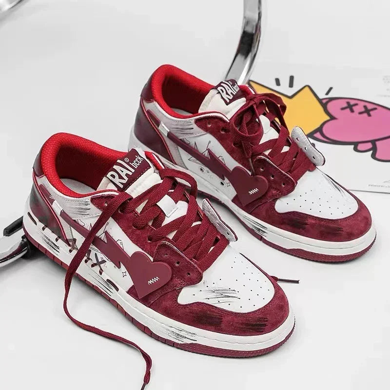 White and maroon sneakers with heart-shaped lace tags and artistic black sketch details on a white surface