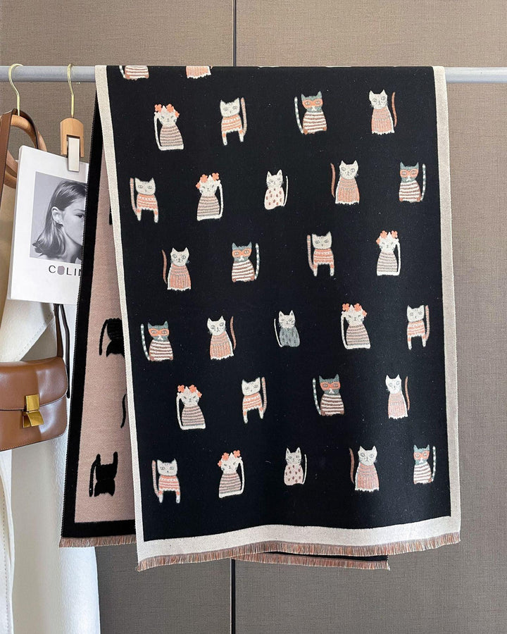Black scarf hanging with cute cat illustrations in pink, white, and gray patterns