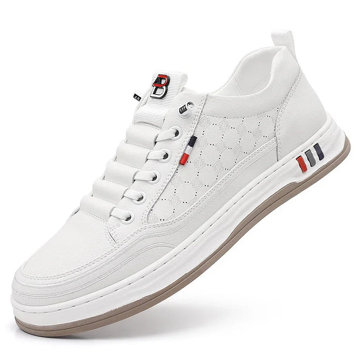 White casual sneaker with patterned side panels, red and navy accents, and beige sole