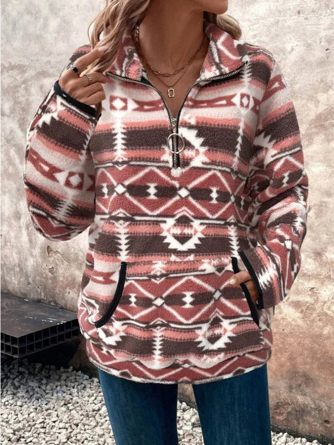 Woman wearing a patterned fleece pullover with half-zip and front pockets, standing outdoors