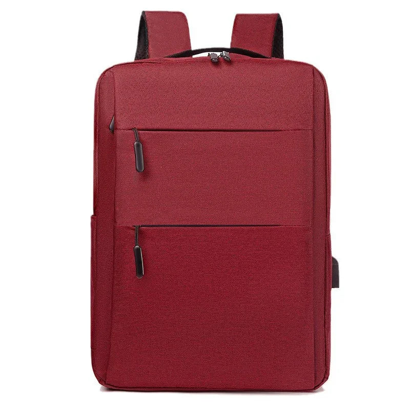 Red rectangular backpack with two front zippered pockets and padded shoulder straps on white background