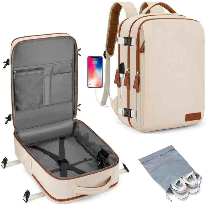 beige travel backpack with brown trim, open view showing compartments, USB charging port, and gray shoe bag with sneakers