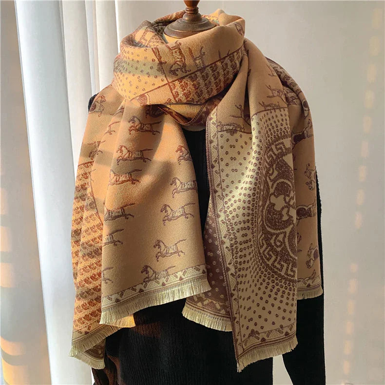 Beige and brown patterned scarf with horse and geometric designs displayed on mannequin